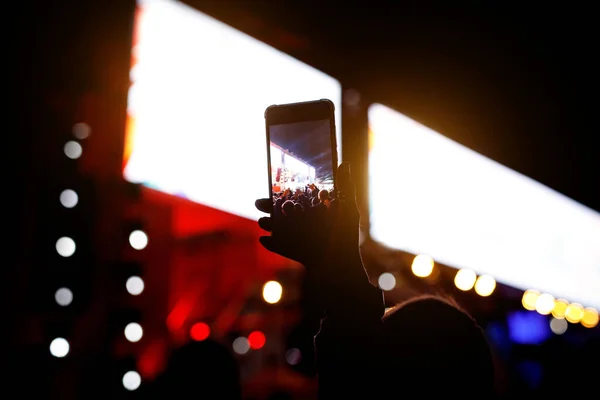 Silhouette of using a mobile phone at a concert