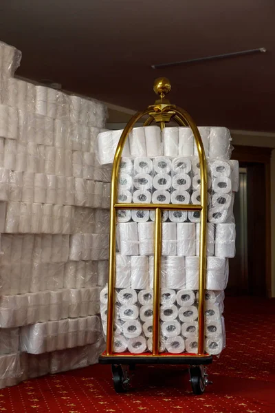 Many rolls of toilet paper in a hotel trolley.