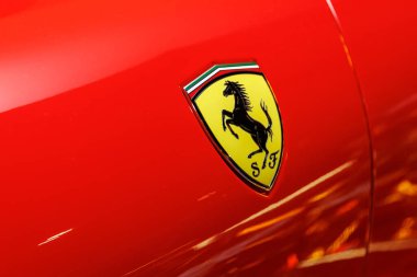 Barselona 'da. İspanya - 21 Ocak 2025: Parlak kırmızı araba yüzeyindeki Ferrari ambleminin detaylı çekimi. İkonik lüks marka ve otomotiv tasarımı kavramı.