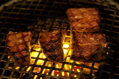 Parlayan sarı közlerin üzerinde metal bir tel askıda kurutulmuş yüksek kaliteli biftek..