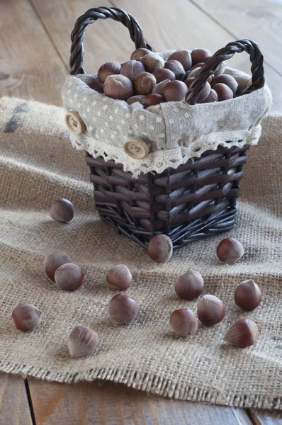 Hazelnuts Wicker Basket Table Covered Burlap Vertical — Stock Photo, Image