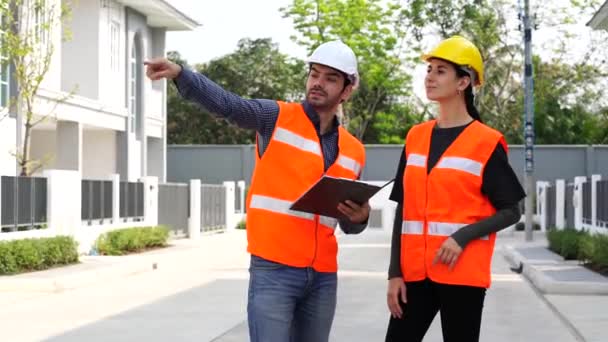 Beautiful Female Engineer Male Foreman Wearing Protective Helmet Talk Together — Stock Video