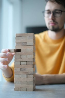 Delikanlı kendini izole ederek evde Jenga oynuyor. Ev eğlencesi. Boş zaman. Roma, İtalya Aralık 2020