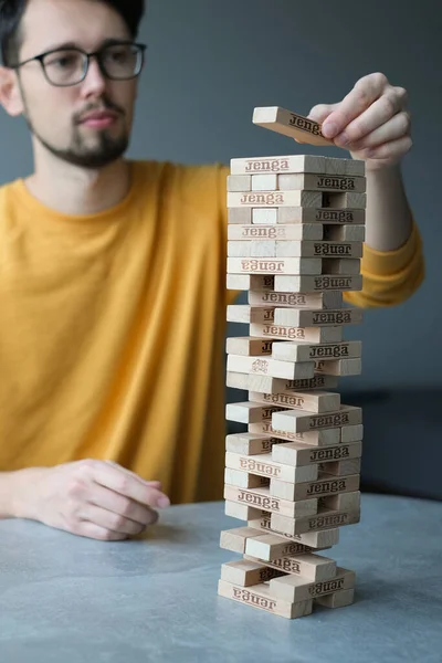 Delikanlı kendini izole ederek evde Jenga oynuyor. Ev eğlencesi. Boş zaman. Roma, İtalya Aralık 2020