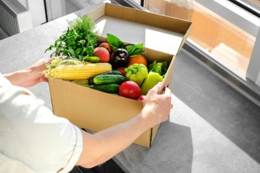 man ordered food delivery to his home. a man unpacks an online order of vegetables and fruits from an online store. fast delivery of fresh products. Food for vegetarian and vegan