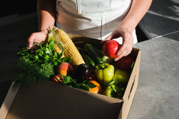 woman ordered food delivery to his home. online order of vegetables and fruits from an online store. fast delivery of fresh products. Food for vegetarian and vegan close-up