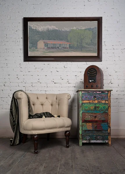 Vintage beige armchair, colorful cupboard, old radio and hanged painting — Stock Photo, Image