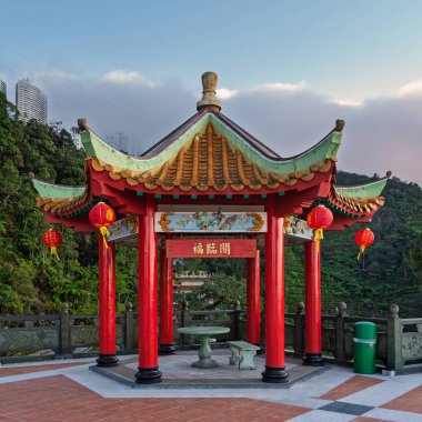 Canlı kırmızı Çin bereketli köşkü, süslü yeşil ve turuncu çatısı, kırmızı fenerleri ve Chin Swee Mağara Tapınağı kompleksi Genting Highlands, Malezya