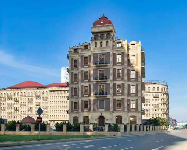 8 Kasım Ave, Bakü, Azerbaycan 'da kırmızı çatılı ve taretli şık bir bina. Kırmızı uçlu çatısı, dekoratif cephesi ve açık mavi gökyüzünün altında balkonları olan ayırt edici bir mimari.