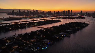 Florida 'daki Miami Beach' te Sunset Bay. Günbatımı Şehri. Aydınlatılmış şehir manzarası. Şehir merkezinde. Florida 'daki Miami Beach' te Sunset Bay. Huzurlu Günbatımı Gökyüzü.