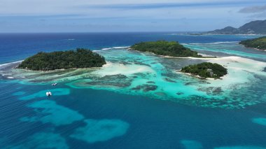 Saint(Anne Marine National Park In Mahe Island Victoria Seychelles. Turquoise Ocean Waves Gently Crashing On Tropical Beach. Shore Horizon Beach Sea. Shore Seaside Panning Wide. Mahe Island Victoria.