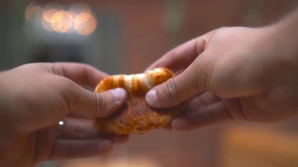 Two hands breaking a cheesy dough ball in two showing its cheese filling — Wideo stockowe