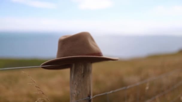 Brown Hat Rests op een houten paal van een draad hek — Stockvideo