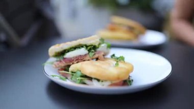 Close-up of a Tasty Meat and Lettuce Panini with a Thick Slice of Cheese in it