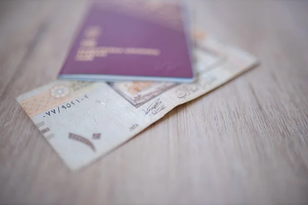 Ten Saudi Riyals Bill Partially Inside a Blurry Sweden Passport — Stockfoto