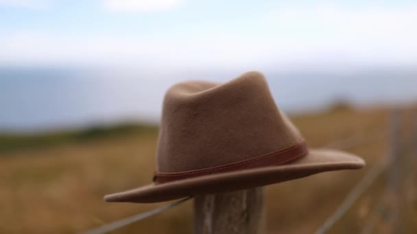 Brown Hat Rests op een houten paal van een draad hek — Stockvideo