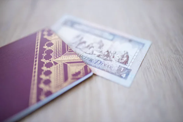 Kuwait Quarter Dinar Bill Partially Inside a Blurry Sweden Passport — Stockfoto