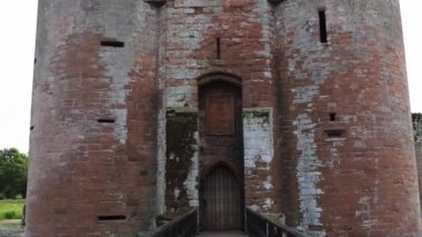 Narrow Bridge That Leads to European Fortress Caerlaverock, Under a Cloudy Sky