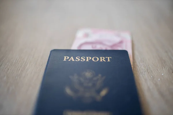United States of America Passport with a 100 Thai Baht Bill Partially Inside — Fotografia de Stock