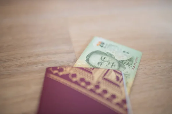 Twenty Thai Baht Bill Partially Inside a Sweden Passport — Stock Photo, Image