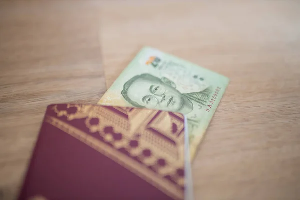 Twenty Thai Baht Bill Partially Inside a Sweden Passport — Stockfoto