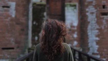 Woman Walking on a Narrow Bridge That Leads to Scottish Fortress Caerlaverock