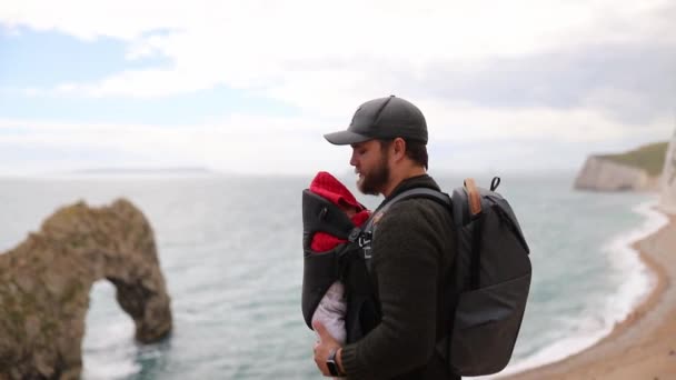 Man With his Baby Enjoys the View of the Jurassic Coast — Stock Video