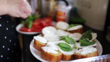 The Preparation of a Bread and Cheese Dish Accompanied by Fresh Green Leaves