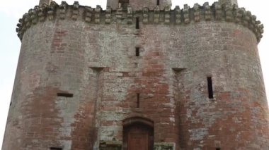 Narrow Bridge That Leads to Scottish Fortress Caerlaverock, Under a Cloudy Sky