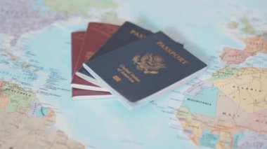 Swedish and American Passports on Top of a Colorful World Map