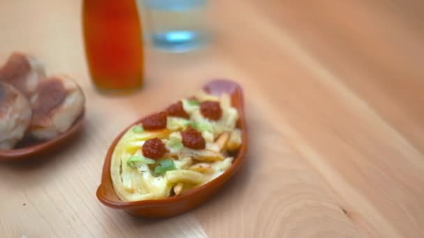 Air fried fries alongside dough balls, a glass and a bottle on a wooden table — Video Stock