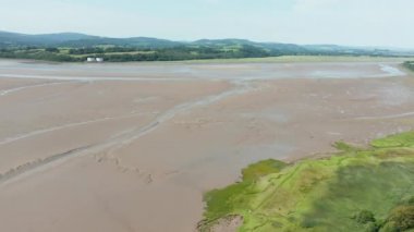 Aerial Landscape View of a slightly cloudy Skyline over a Vast Muddy land