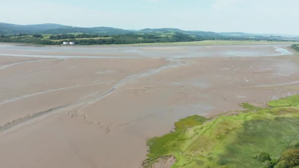 Aerial Landscape View of a slightly cloudy Skyline over a Vast Muddy land — Stockvideo