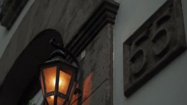 Spanish Restaurant with a Traditional Lamp Hanging Next to Address Number 55