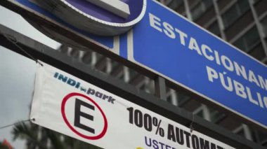 Public Parking 100 Percent Automatic Sign with a Building as Background
