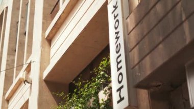 Cream Color Building with a White Sign Next to the Entrance