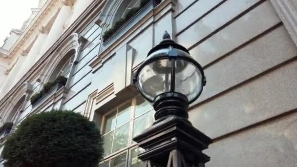 Circling View of a Lamp From a Large White Building With Classic Architecture — Αρχείο Βίντεο