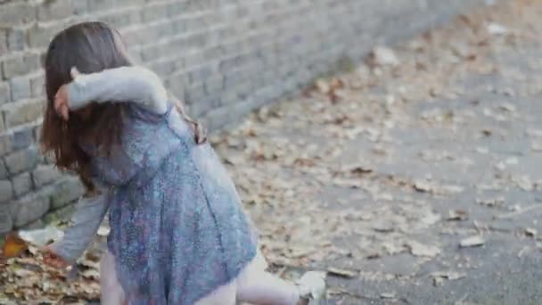 La bambina muove i capelli dopo essersi alzata dal marciapiede — Video Stock
