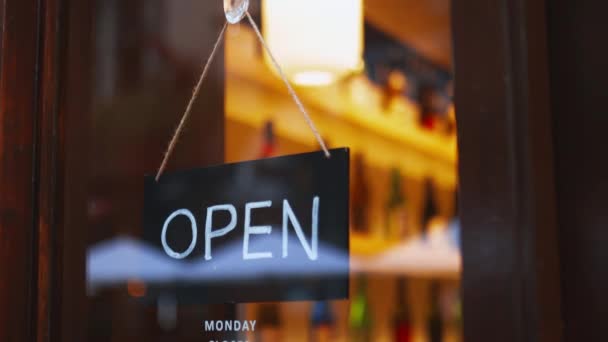 Close up view of an Open sign hanging on the glass door of a Japanese sake bar — Video Stock