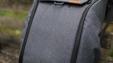 Bir Peak Design fotoğrafçı sırt çantasının dış görünüşünü gösteren erkek el.
