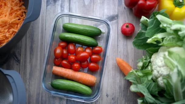 Zanahorias, pepino, tomates y más verduras en una mesa de madera — Vídeo de stock