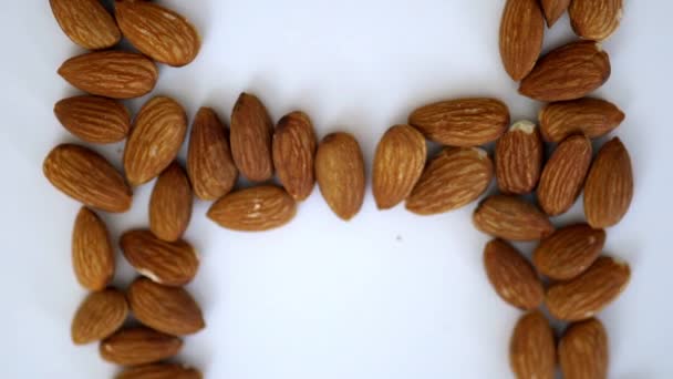 Letras del NHS hechas con almendras sobre una mesa blanca — Vídeos de Stock