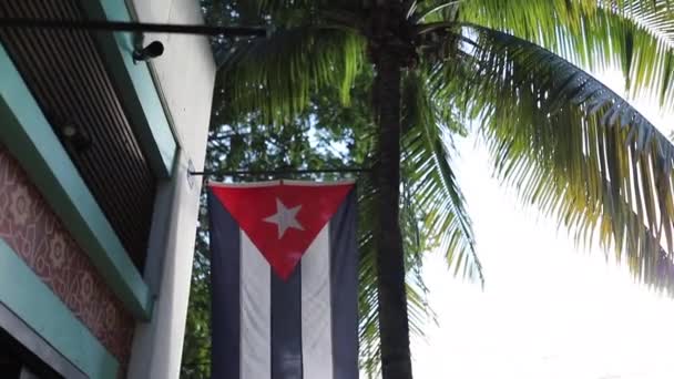 Ver Escaneando una bandera cubana en el frente de un edificio y luego girando — Vídeo de stock