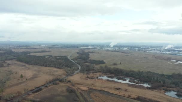 4k空中俯瞰绿地，朝烟道林立的工业区飞去 — 图库视频影像