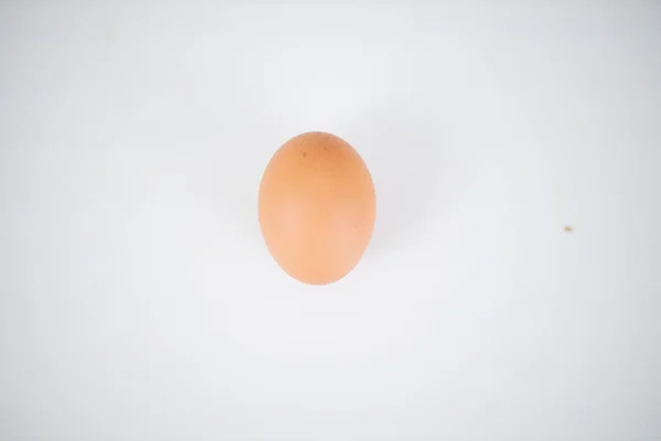 Egg isolated on a white table from above — Stock Photo, Image