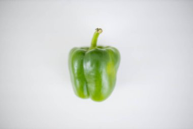 Yeşil dolma biber beyaz bir masada izole edilmiş.