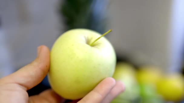 Female hand putting an apple in a glass container with fruit — Stock Video