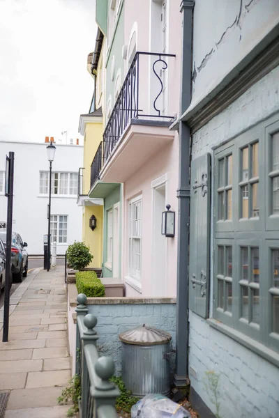 Row of colorful British houses with balconies and plants — Stock Photo, Image