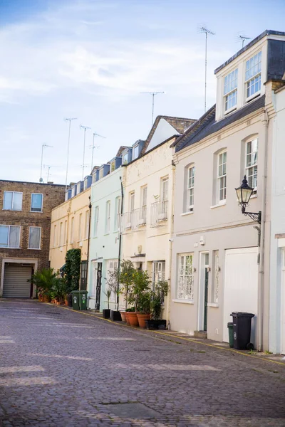 Row of colorful British houses with plants outside their windows — Stock Photo, Image