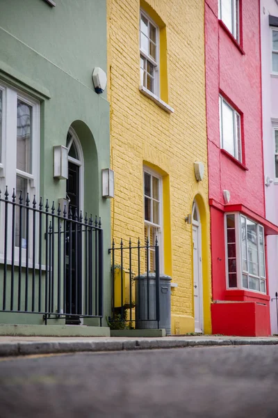 Row of colorful British houses with handrails and plants — Stock Photo, Image